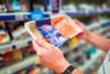 man holding scottish salmon in supermarket - getty