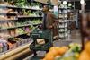 Man Shopping For Fresh Produce In a Grocery Store Aisle