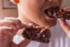 Child eating chocolate crispy bar with insects on