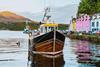 Fishing boat moored in the colorful harbor of portree, isle of skye, scotland - Getty Images