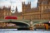 Red double-decker bus crossing Westminster Bridge in London UK - Getty