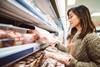 Woman shopping for meat at a supermarket
