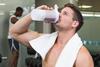 man drinking protein shake gym