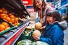 happy family fruit aisle supermarket shopper melon