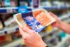 Man holding Scottish salmon fillet in fish aisle of supermarket - stock photo