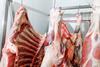 red meat hanging in abattoir