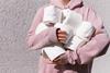 woman-in-pink-long-sleeve-hoodie-carrying-tissue-rolls-3962433