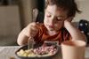 child kid eating dinner lunch family meal potatoes healthy GettyImages-1326427213