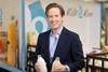 Patrick Müller, CEO for Milk & More holding two bottles