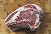 Raw prime rib of beef on a chopping board - stock photo