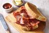 Bacon on bread with knife