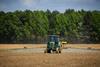 tractor spraying crops in field