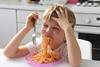 child kid eating meal spaghetti pasta dinner children family GettyImages-1138727508