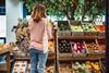 Woman shopping for fresh organic produce in a local grocery store - stock photo