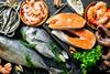 Fresh salmon steak with a variety of seafood and herbs - Getty