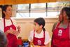 Two women and a child cooking