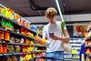 young youth adult gen z grocery supermarket store phone shopper GettyImages-1396834809