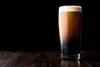 Stout beer on wooden surface
