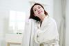 Woman drying hair with a towel