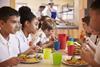 children eating school lunch - getty