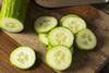 Cucumber cut up on a wooden chopping board