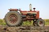Old tractor on Iowa farm. - stock photo
