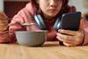 child eating phone social media advertising kids children