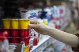 Shopper buying yoghurts