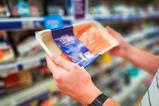 man holding scottish salmon in supermarket - getty