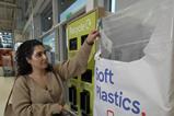 Shopper recycling soft plastic tesco