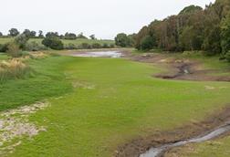 At the end of a dry summer, the water level of Staunton Harold Reservoir is very low, allowing grass to grow over the reservoir bed - The Grocer