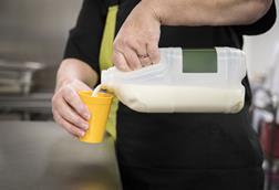 milk being poured into a cup