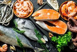 Fresh salmon steak with a variety of seafood and herbs - Getty
