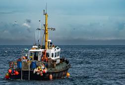 Commercial Fishing Trawler On The Calm Water Of The Atlantic Ocean In Scotland, UK - stock photo - Getty Images