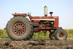 Old tractor on Iowa farm. - stock photo