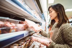 Woman shopping for meat at a supermarket