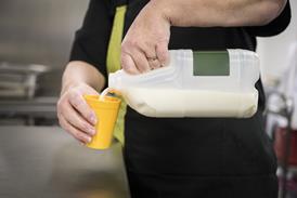 milk being poured into a cup