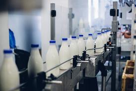 milk bottles on conveyer- getty