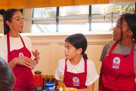 Two women and a child cooking