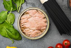 Tuna canned fish seafood, on gray stone table background, top view flat lay - Getty