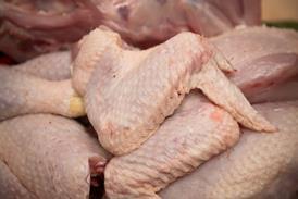 Butcher cutting organic chicken - getty