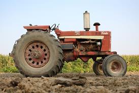 Old tractor on Iowa farm. - stock photo