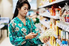 A young woman looking up the ingredients -Getty