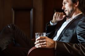 Man drinking whisky stock image