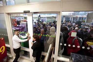 AT THE DOORS: Crowds of excited shoppers wait outside the Asda store in Wembley for the highly anticipated Black Friday sales. This years offers are 3 x times bigger and better than last year, with double the number of ranges on offer in 441 of its stores