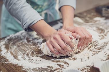 Person rolling out dough flour