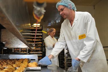 WC Rowe makes living wage commitment, man in bakery baking bread