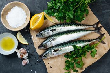 Fresh mackerel fish with ingredients to cook - stock photo