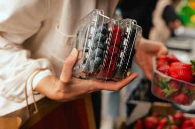berries in plastic containers - getty