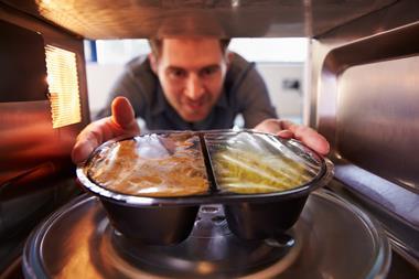 Man with microwave ready meal